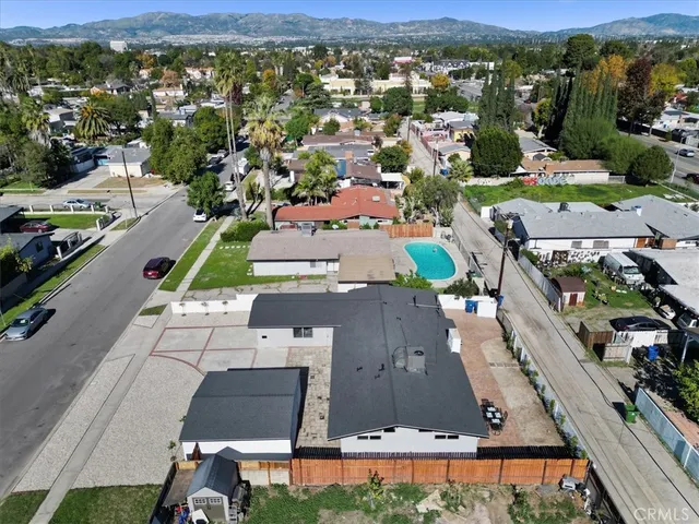 a swimming pool with outdoor seating and trees