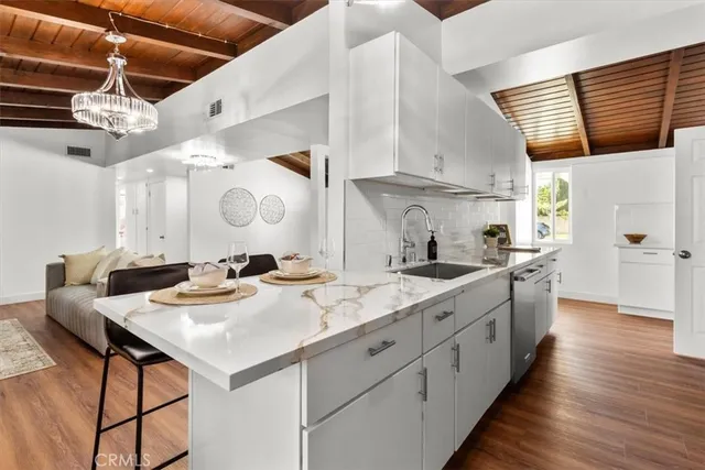 a kitchen with a sink cabinets and wooden floor
