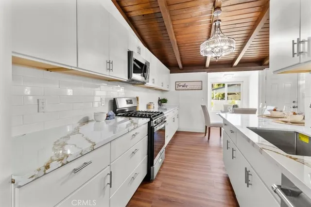 a bedroom with bed and wooden floor