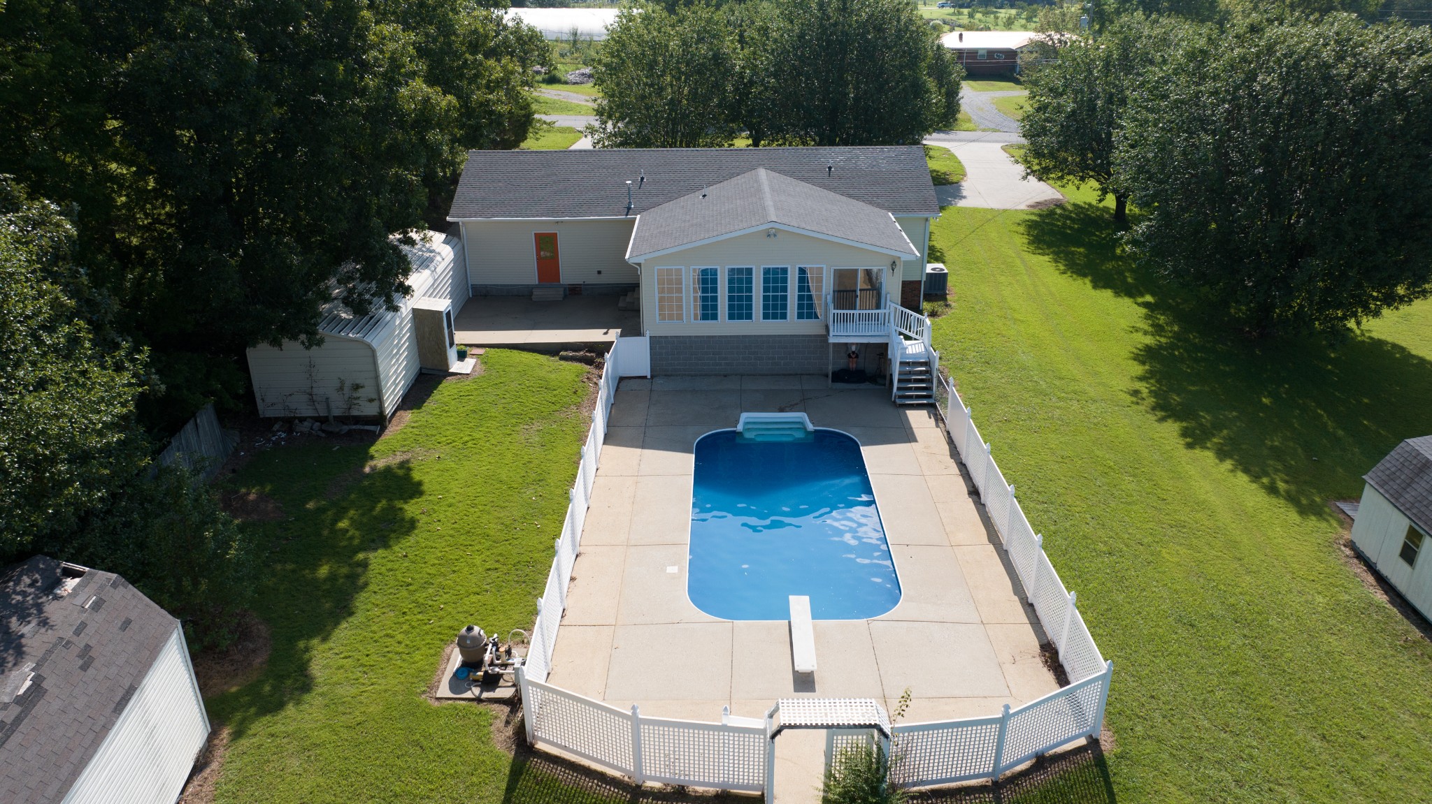 a aerial view of a house with swimming pool garden and patio