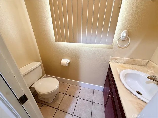 a view of an empty room and a kitchen