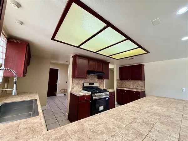 a kitchen with a sink a counter top space and cabinets