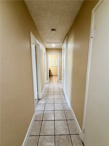 an empty room with a ceiling fan and window