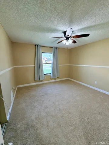 an empty room with closet and windows