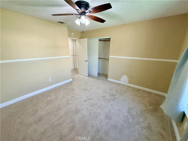 a bathroom with a granite countertop sink a mirror and a bathtub