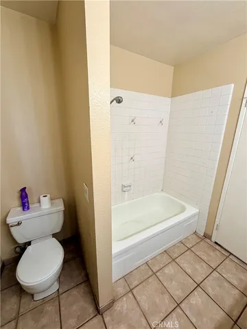 a view of a hallway to a livingroom with furniture