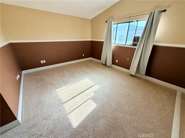 a front view of a house with a big yard and potted plants
