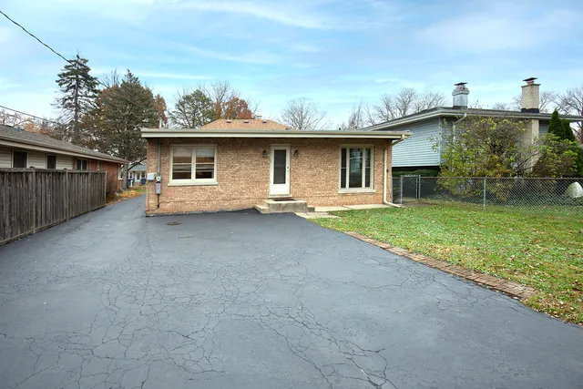 a view of a house with a backyard and a patio