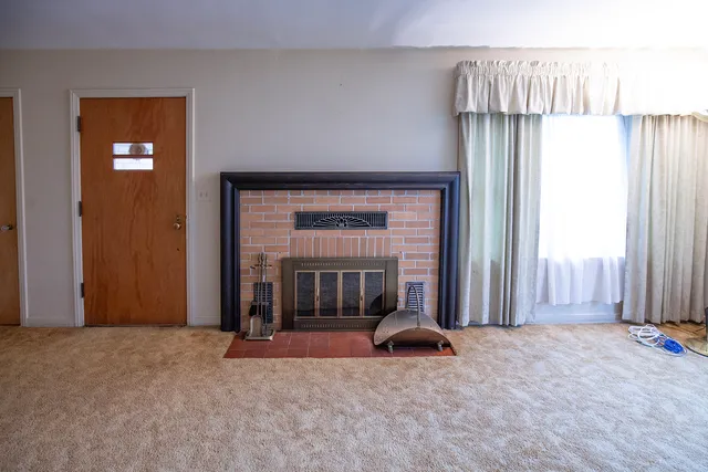 a view of a room with large windows and a livingroom