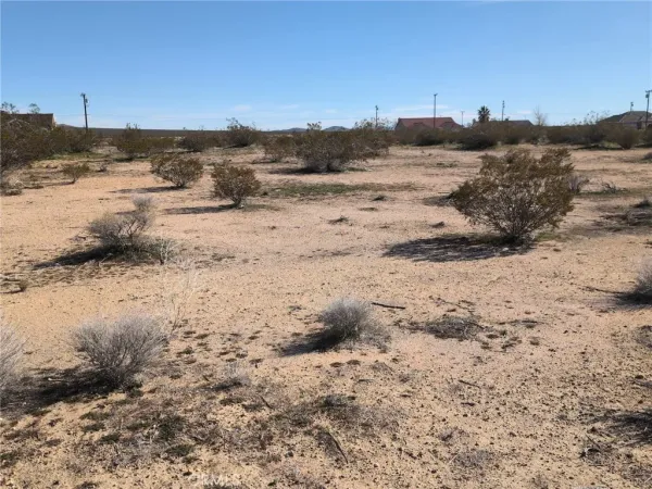 a view of ocean beach and mountain