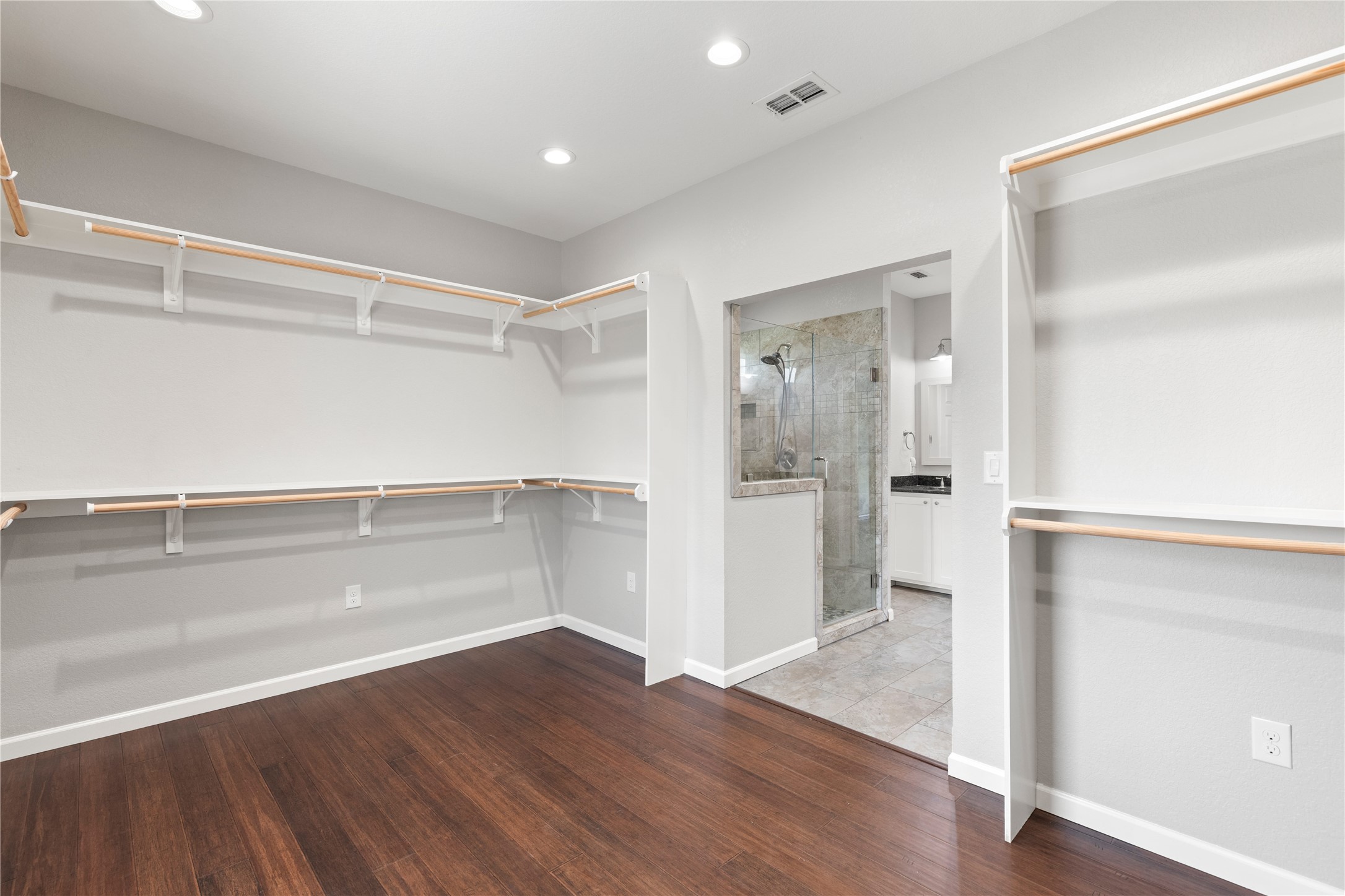 1293 Pioneer Road Seguin, TX 78155 - Photo 20 of 40 A spacious walk-in closet with ample shelving and a seamless connection to the primary bathroom.