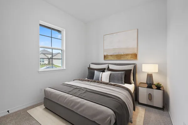 a bedroom with a bed and a lamp