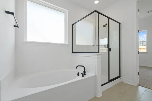 a bathroom with a double vanity sink mirror and shower