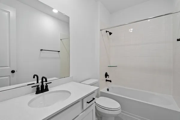 a bathroom with a sink toilet tub and shower