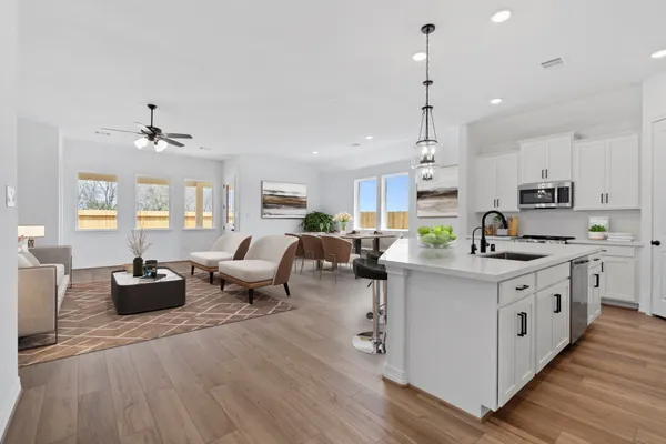 a open kitchen with stainless steel appliances granite countertop a lot of counter space and wooden floors