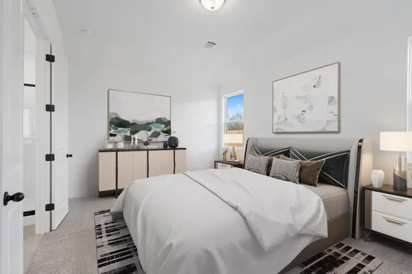 a bedroom with a bed and a painting on the wall
