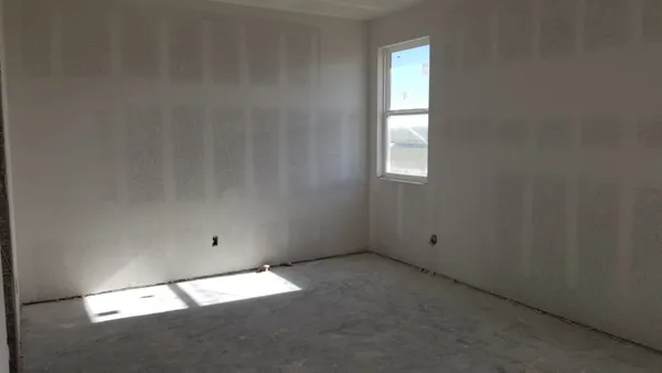 an empty room with a empty space and window