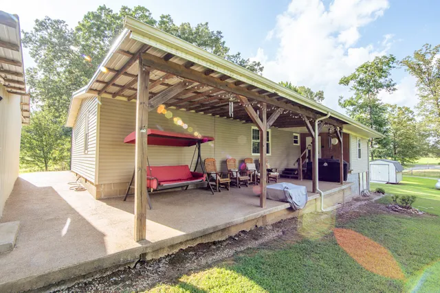 a spacious bedroom with a bed and a flat screen tv