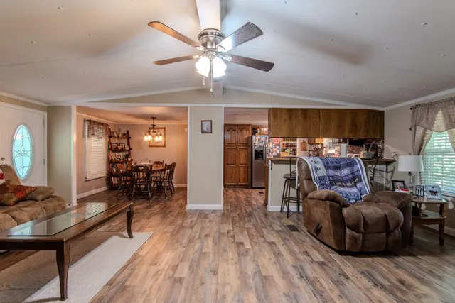 a kitchen with stainless steel appliances granite countertop a refrigerator a stove a sink dishwasher and a microwave oven with wooden floor