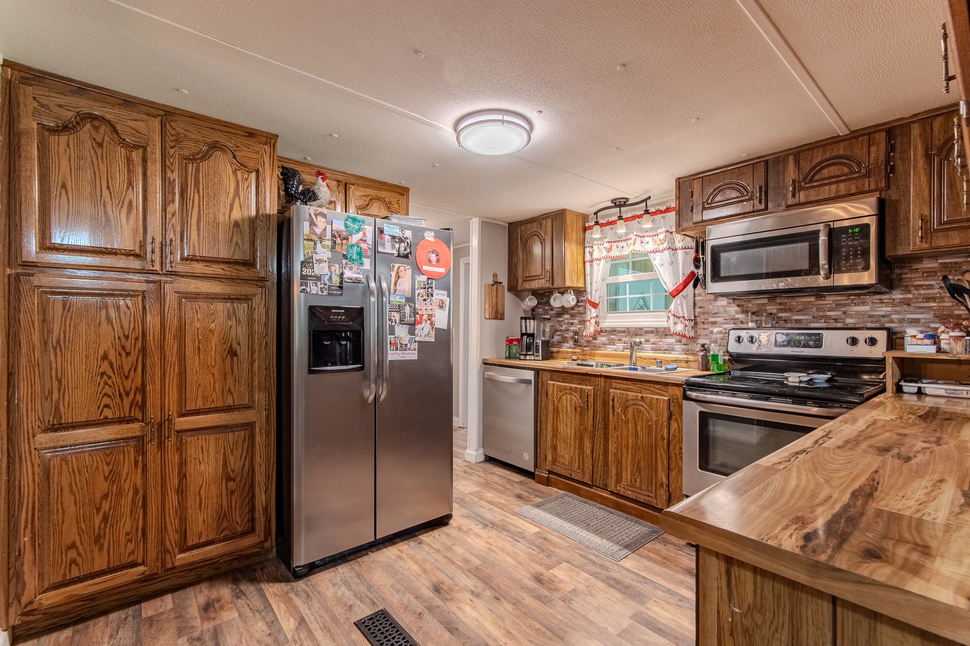 3130 Nance Bend Road Clifton, TN 38425 - Photo 23 of 76 a kitchen with granite countertop stainless steel appliances a refrigerator stove top oven and sink