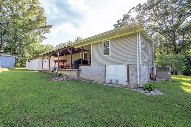 a view of a house with a yard and deck