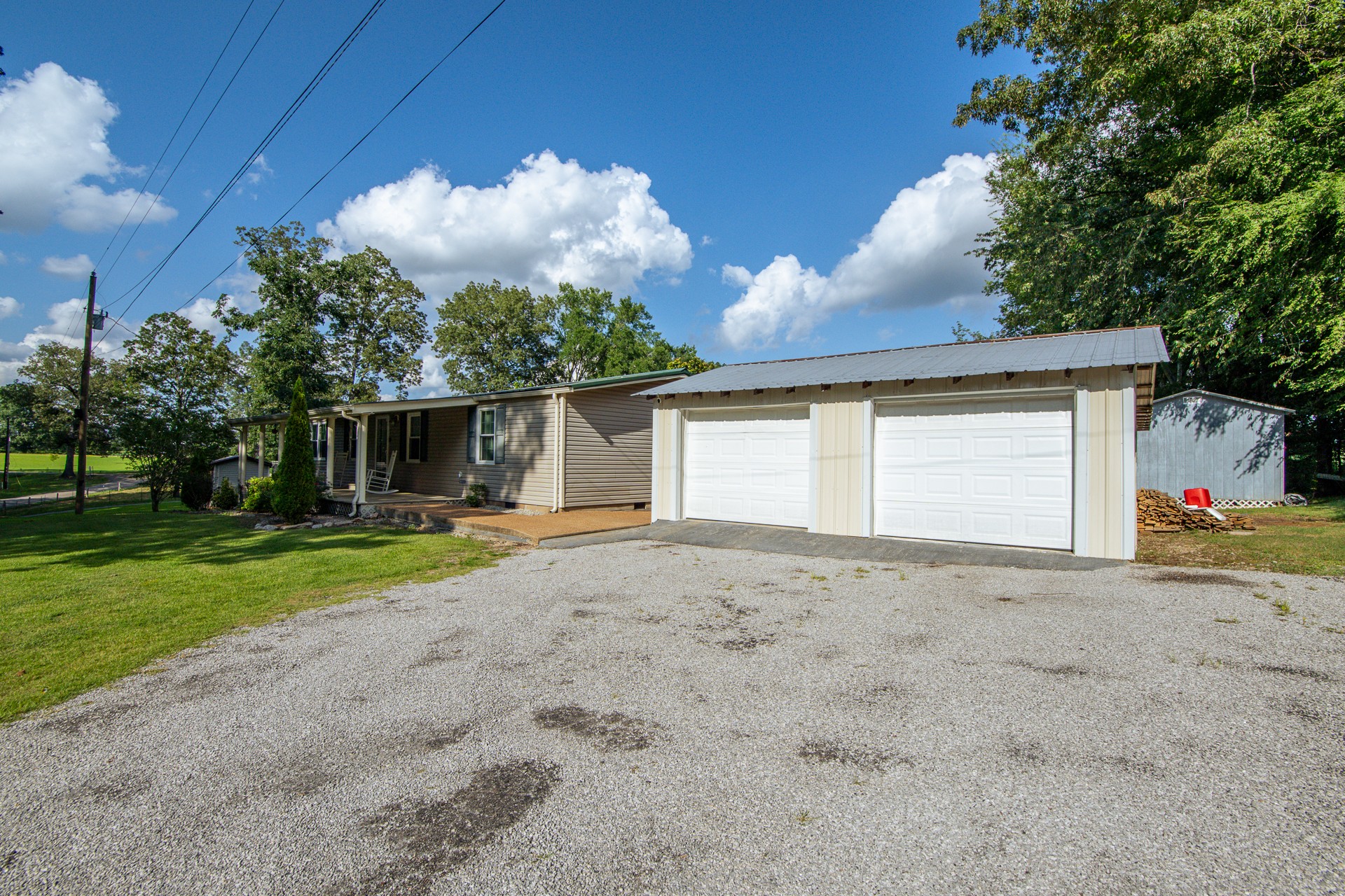 3130 Nance Bend Road Clifton, TN 38425 - Photo 48 of 76 a front view of a house with a yard and garage