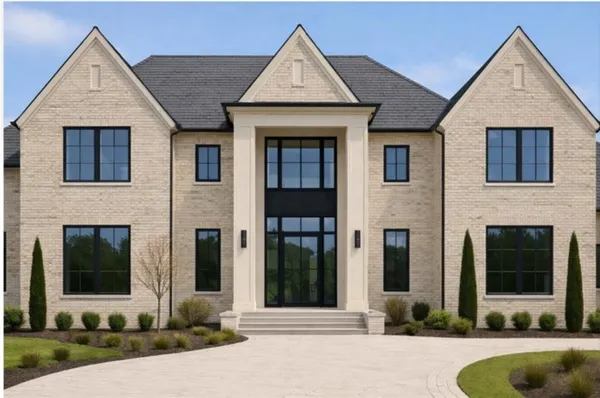 a view of a brick house with large windows and plants