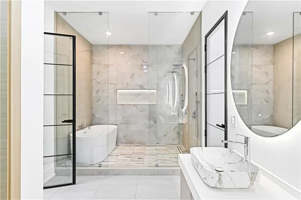 a bedroom with a large bed and a large window