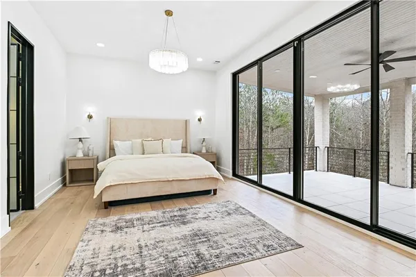 a view of an empty room with a window and kitchen view