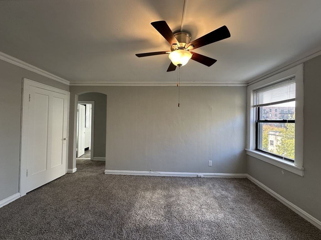 661 West Sheridan Road, Unit 601 Chicago, IL 60613 - Photo 13 of 20 a view of an empty room with window and chandelier fan