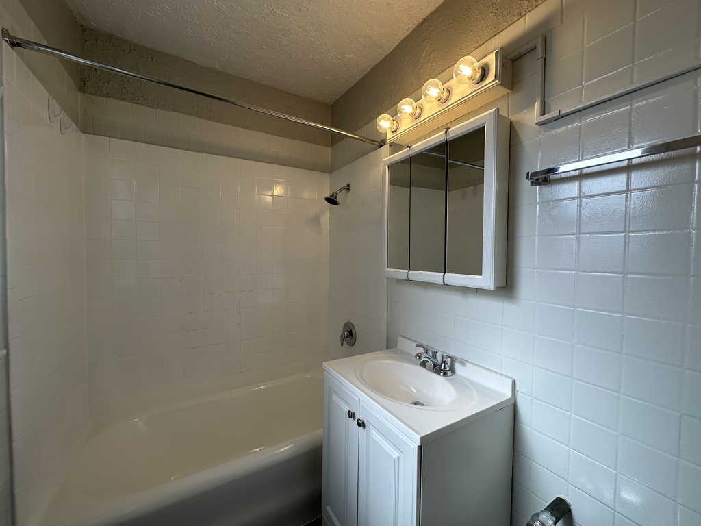 661 West Sheridan Road, Unit 601 Chicago, IL 60613 - Photo 18 of 20 a bathroom with a sink and a mirror