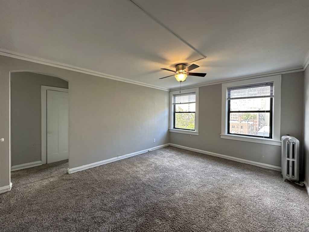 661 West Sheridan Road, Unit 601 Chicago, IL 60613 - Photo 6 of 20 an empty room with windows and fan