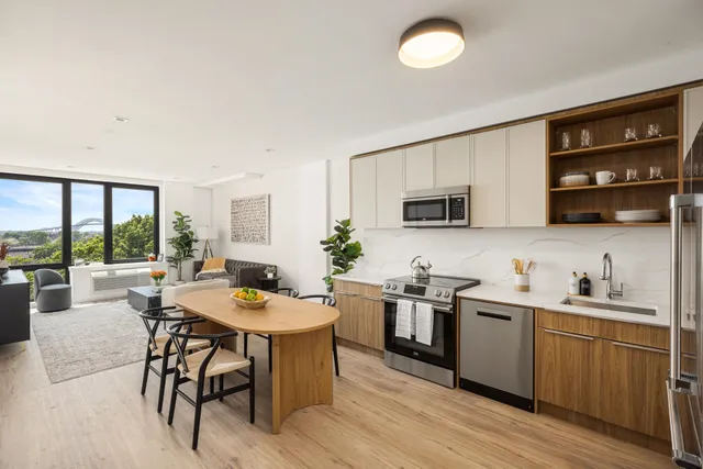 a kitchen with stainless steel appliances kitchen island granite countertop a sink and cabinets