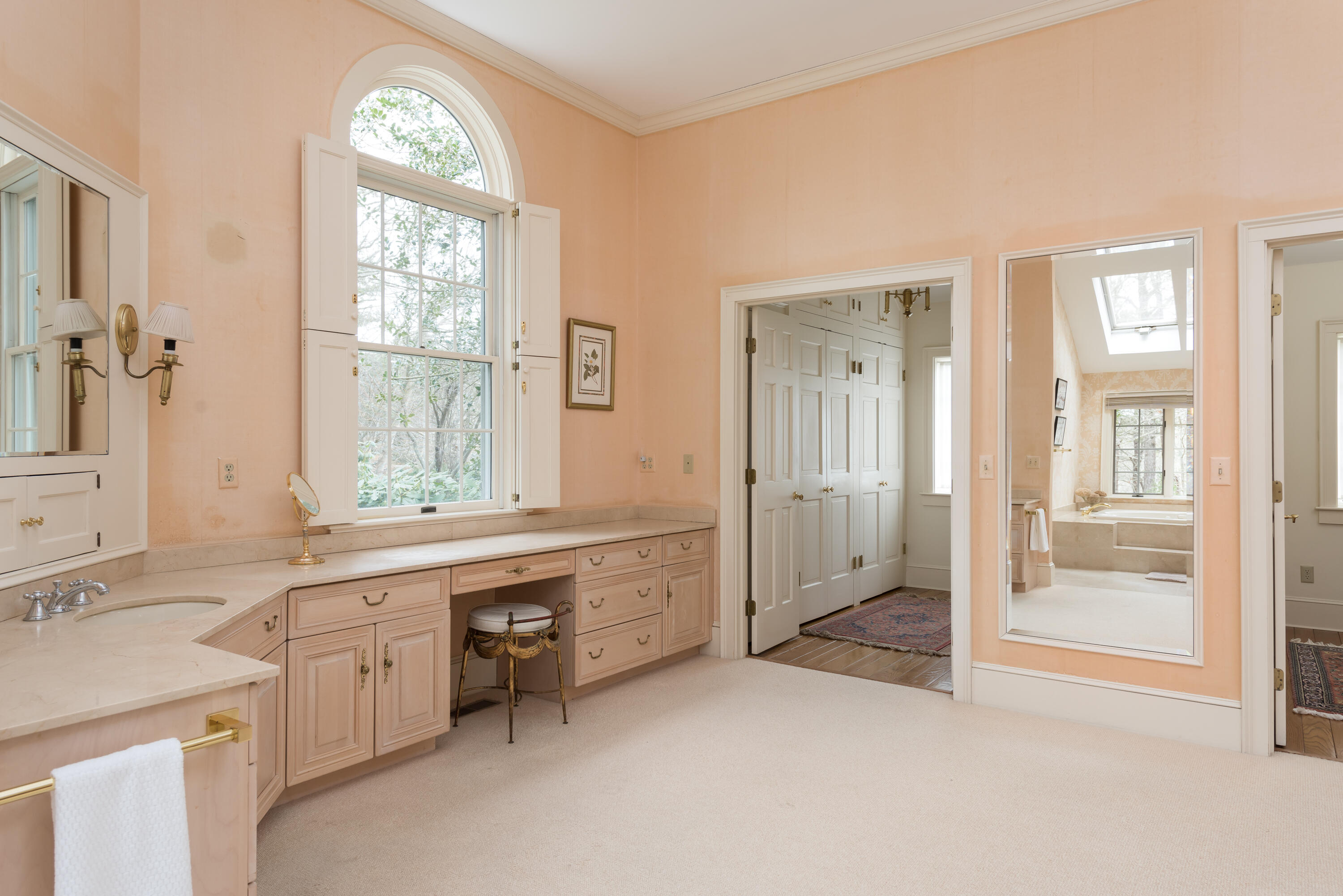 100 Ice Valley Road Osterville, MA 02655 - Photo 16 of 22 a bathroom with a sink mirror and a bathtub next to a window