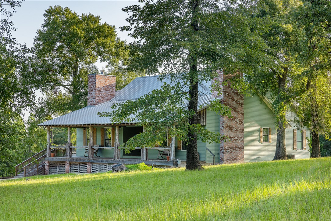 5107 Bovista Ranch Road Navasota, TX 77868 - Photo 16 of 50 a view of a house with a yard porch and sitting area
