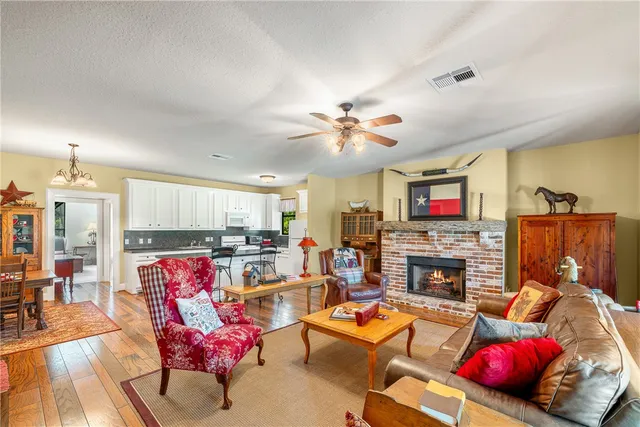 a living room with furniture fireplace and kitchen view