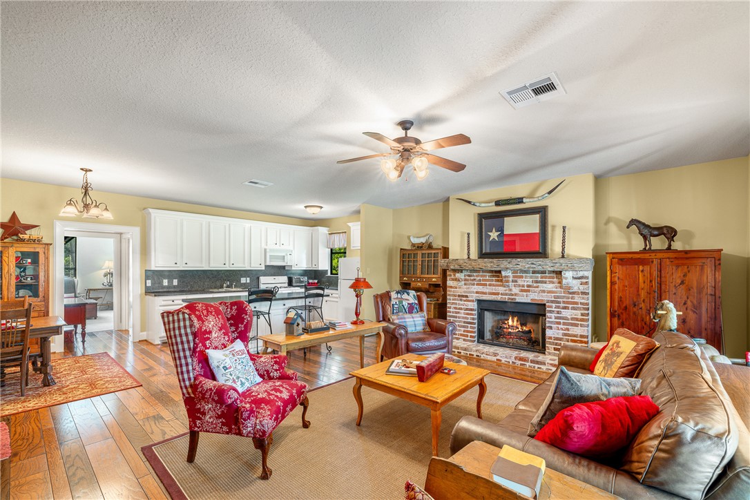 5107 Bovista Ranch Road Navasota, TX 77868 - Photo 17 of 50 a living room with furniture fireplace and flat screen tv