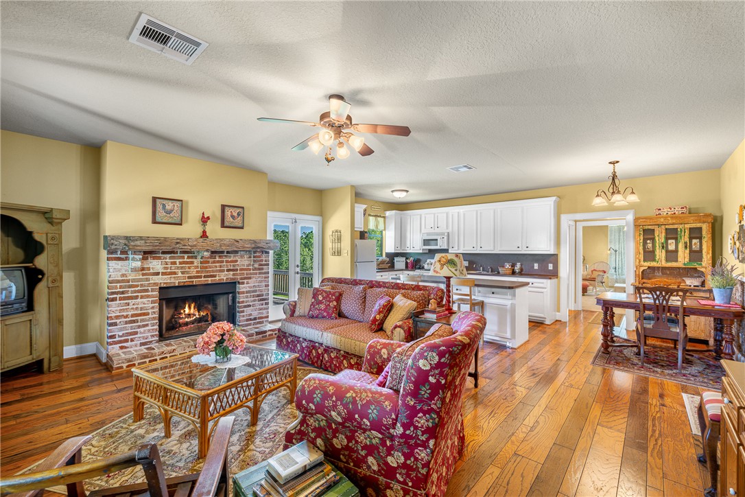 5107 Bovista Ranch Road Navasota, TX 77868 - Photo 50 of 50 a living room with furniture fireplace and kitchen view