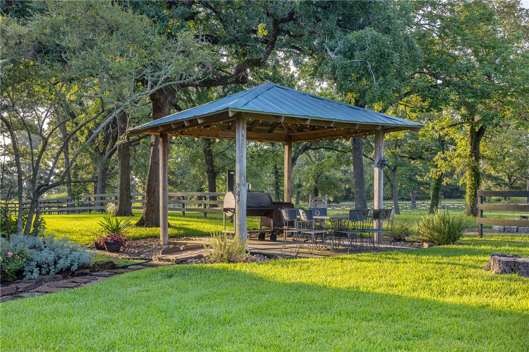 5107 Bovista Ranch Road Navasota, TX 77868 - Photo 6 of 50 a view of a house with a backyard patio and swimming pool