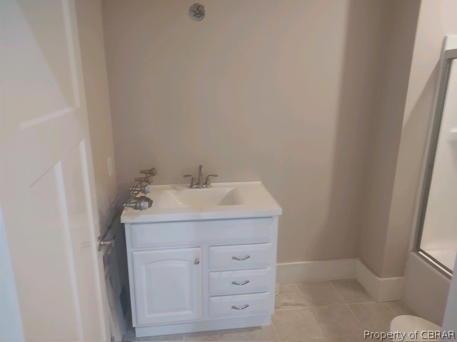 173 Lillys Neck Road Moon, VA 23119 - Photo 33 of 48 Bathroom featuring vanity, tile floors, and shower / bath combination