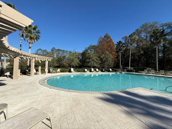 a view of a swimming pool and a yard