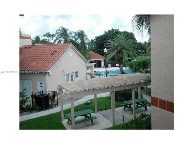 a view of house with backyard and outdoor seating