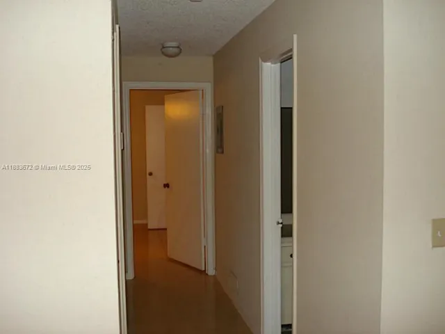 a view of a bathroom from a hallway