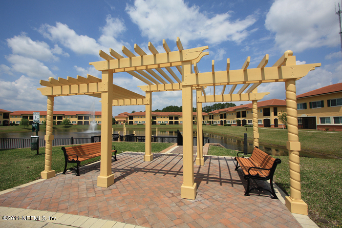 9745 Touchton Road, Unit 2625 Jacksonville, FL 32246 - Photo 17 of 18 a swimming pool with outdoor seating and yard