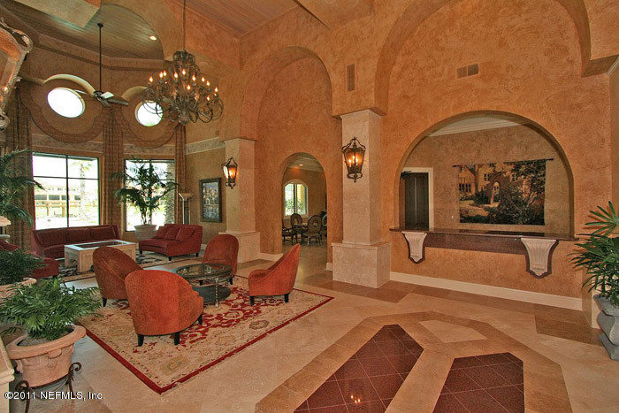 9745 Touchton Road, Unit 2625 Jacksonville, FL 32246 - Photo 6 of 18 a living room with furniture a chandelier and a large window