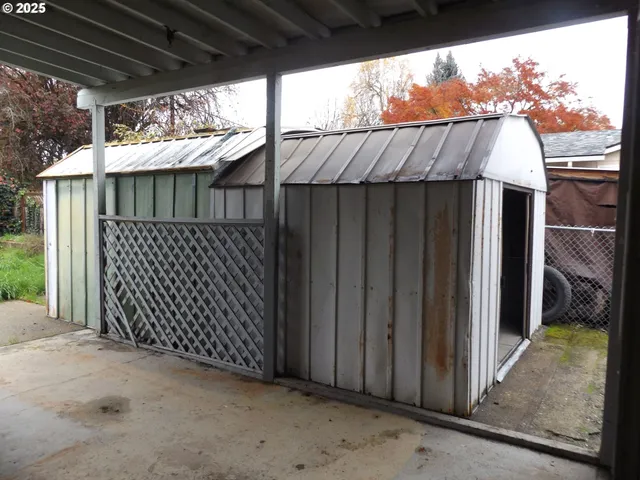 a view of a house with wooden fence
