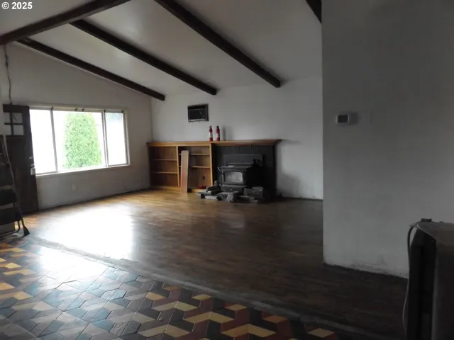 a view of a livingroom with furniture and a window