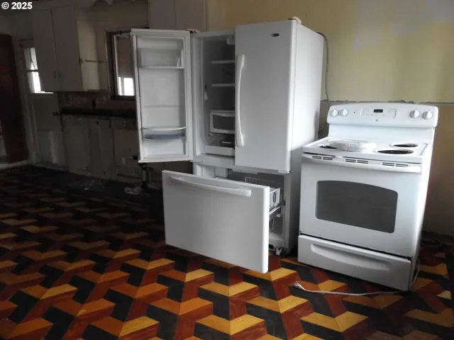 a kitchen with a stove and a refrigerator