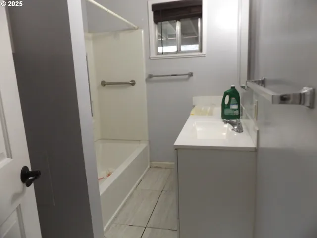 a bathroom with a sink and mirror