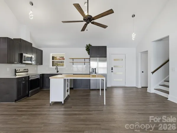 a large kitchen with a large counter top appliances and cabinets